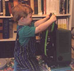 (Picture of Henry trying to load a film on the projector)
